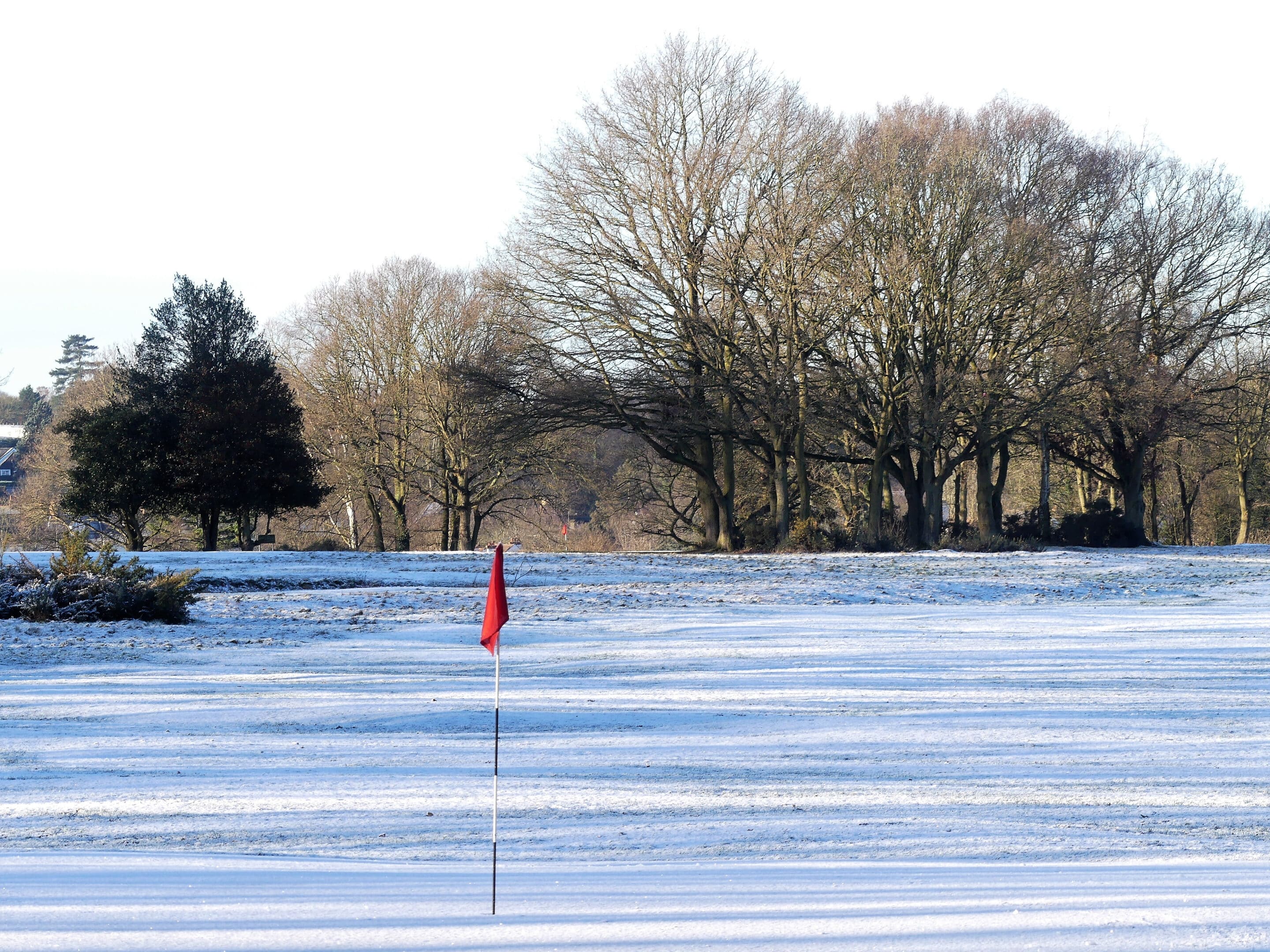 Snow Covered Golf Course With Red Flag On Chorleywood Common